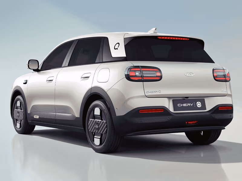 Rear three-quarter with the matching circular Q tail lights and roof spoiler